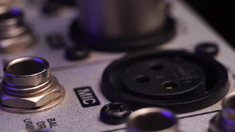 Plug-In-XLR-Microphone-Connector-and-Cable-to-Mixing-Console,-Macro-Close-Up