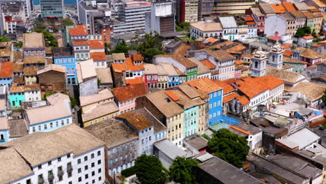 Aerial-view-of-the-houses-and-buildings-on-the-Pelourinho-neigbourhood-and-the-sea-at-background,-Salvador,-Bahia,-Brazil