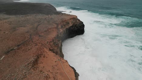 Top-view-of-dangerous-high-tides-hitting-the-rocks-of-Cape-Bridgewater,-Australia