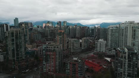 Drohnenschuss-über-Dem-David-Lam-Park-Mit-Blick-Auf-Die-Skyline-Von-Vancouver-Und-Die-Berge-Im-Hintergrund-An-Einem-Bewölkten-Tag-Im-Frühling
