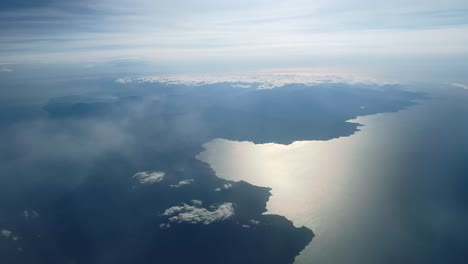 Aerial-panoramic-view-above-clouds-of-Corsica-island-and-coastline-in-France