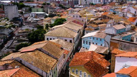 Aerial-view-of-the-houses-and-buildings-on-the-Pelourinho-neigbourhood-and-some-people-walking-around,-Salvador,-Bahia,-Brazil
