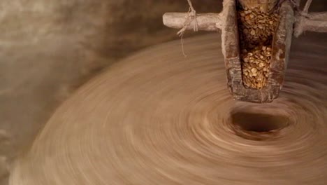 Woman-milling-grain,-to-make-flour