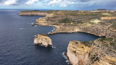 Drone-view-of-Inland-Sea-in-Dwejra-Bay-with-Fungus-Rock,-colapsed-Azure-Window,-underwater-cave