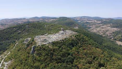Drone-orbiting-around-the-hill-where-an-ancient-historical-landmark-called-Perperikon-is-located,-in-Kardzhali-province,-Bulgaria