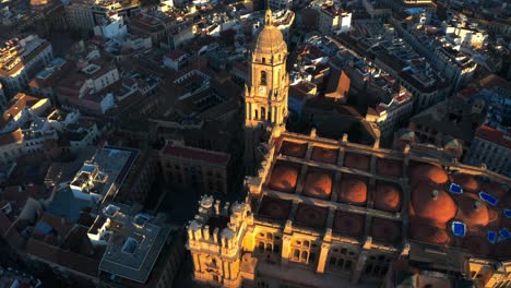 Aerial-dorne-fly-above-cathedral-of-Malaga-Andalusia-Spain-Renaissance-Building-in-Spanish-City-at-daylight,-revealing-mediterranean-mountain-range