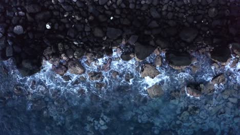 Aerial-view-of-waves-crashing-on-rocks