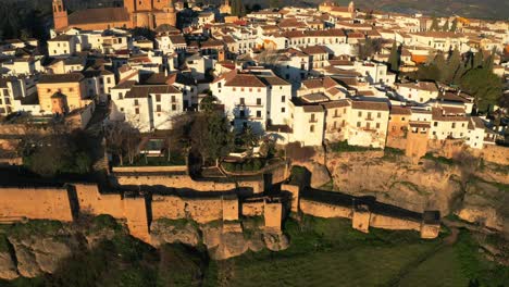 Aerial-drone-panoramic-canyon-bridge-Puente-Nuevo-traditional-white-Spanish-houses-in-Ronda,-Andalucia-city-Iberian-landscape,-mediterranean-mountain-background