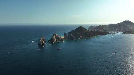 Aerial-view-approaching-the-cape-at-Cabo-San-Lucas,-sunny-day-in-Mexico