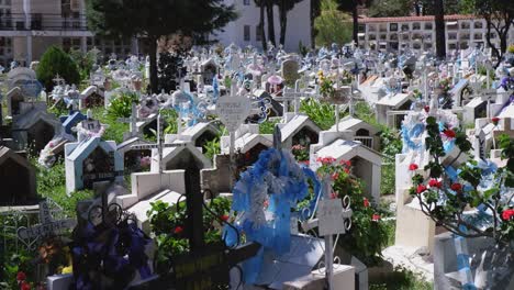 Pan-across-crowded-gravestones-and-mausoleums-in-Bolivian-cemetery