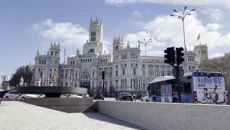 View-of-the-busy-roundabout-at-Cibeles-fountain-with-the-iconic-tourist-attraction-of-Cibeles-palace-in-Madrid