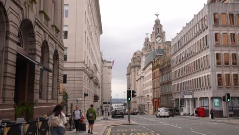 Downtown-Liverpool-UK-Street-Traffic,-People-on-Pavement-by-Historic-Buildings-Near-Docks-60fps