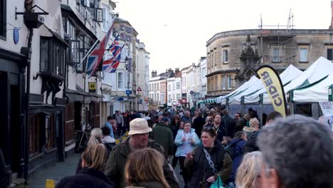Crowds-of-people-visiting-and-shopping-at-Wells-Market-Place-and-high-street-on-busy-Easter-Weekend-in-Somerset,-Southwest-of-UK