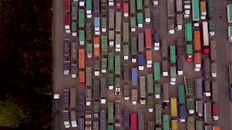 Aerial-top-view-of-colorful-cargo-trucks-in-lot