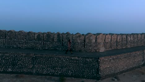 Aerial-View-Of-Person-Walking-Along-Defence-Wall-At-Ranikot-Fort