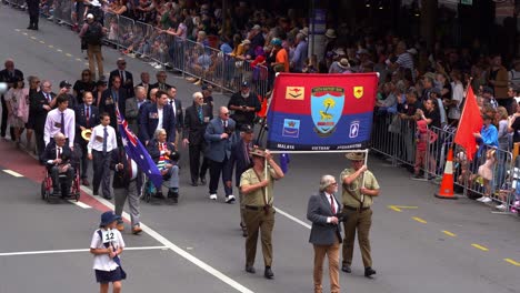 Representatives-from-the-105-Battery,-Royal-Australian-Artillery-Association,-participate-in-Anzac-Day-parade-in-downtown-Brisbane,-honouring-those-who-served-and-sacrificed-amidst-cheering-crowds