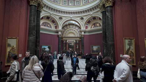 Room-36,-home-to-Claude-and-Turner-paintings-at-the-National-Portrait-Gallery-in-London,-visitors-delight-in-the-artistic-treasures-on-display