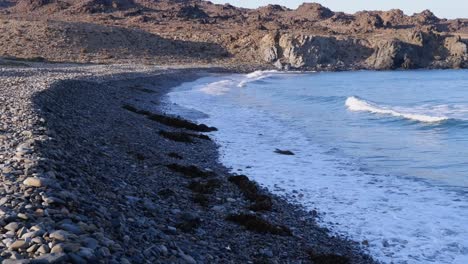 Small-ocean-waves-break-onto-steep-pebble-beach-in-Chile-Atacama-coast