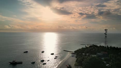 Sunset-sky-reflecting-on-Indian-Ocean-at-Fulidhoo-island,-Maldives,-Aerial