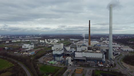 Chimney-Emissions-of-Waste-fired-Power-Plant-at-Industrial-Park,-Drone-Shot