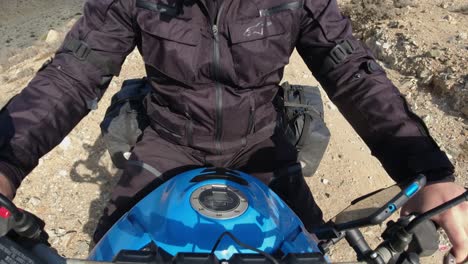 POV-motorcycle-rider-selfie-on-rustic-gravel-hilltop-ridge-road,-Chile