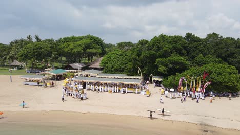 Aerial-view,-procession-on-Samuh-beach-during-the-Melasti-ceremony-before-the-silent-day-of-Nyepi