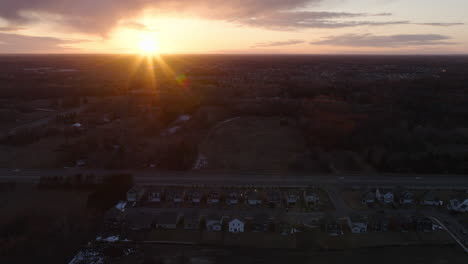 Suburb-neighborhood-in-dramatic-sunset-light,-aerial-orbit-Minnesota,-USA