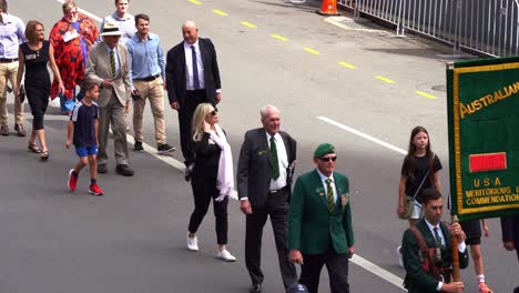 Representatives-and-families-from-the-Australian-Army-Training-Team-Vietnam-walking-down-the-street,-participating-the-annual-Anzac-Day-parade