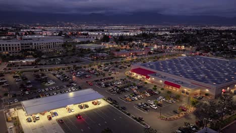 timelapse-of-hotels-and-commercial-buildings-with-lots-of-lights-and-moving-traffic-at-night-time-in-San-Bernardino-California-west-coast-transitioning-to-dark-scene-AERIAL-DOLLY-PUSH
