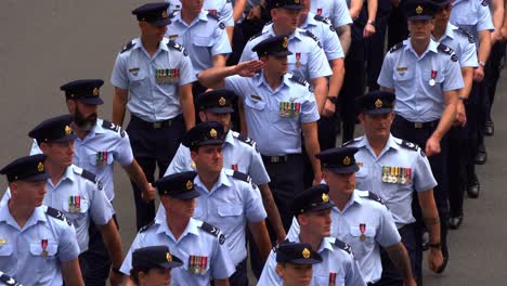 Large-group-of-disciplined-service-men-and-women-from-Royal-Australian-Air-Force-uniformly-marching-down-the-street,-Brisbane-city,-amidst-the-solemnity-of-the-Anzac-Day-commemoration,-close-up-shot