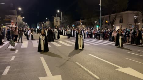 We-see-the-procession-in-formation-in-the-foreground,-the-acolytes-followed-by-the-banner-of-the-Virgin-and-behind-the-rest-we-see-a-faithful-with-a-cape-coordinating-the-formation-with-gestures