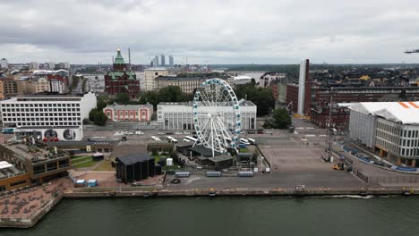 big-Ferris-wheel-in-the-city,-city-skyline,-helsinki,-finland,-europe,-drone