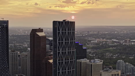 Calgary-AB-Canada-Aerial-v54-zoom-view-tracking-shot-drone-capturing-Beltline-and-Downtown-Commercial-cityscape-on-the-skyline-with-beautiful-golden-sunset---Shot-with-Mavic-3-Pro-Cine---July-2023