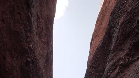 Two-Moroccan-kids-runing-narrow-slot-canyon---gorge-Dades