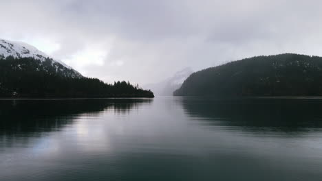AERIAL:-Foggy-Mountain-Shot-over-Lake-in-Alaska-Wilderness