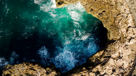 Powerful-spray-produced-as-waves-crash-against-rocky-cliffs