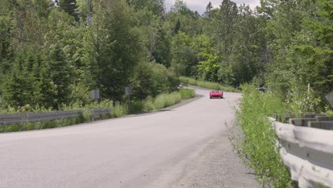 Red-Ferrari-355GTS-driving-on-a-country-road---Long-shot