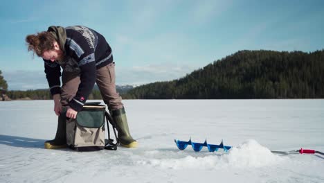 Un-Hombre-Se-Prepara-Para-Pescar-En-El-Hielo-Sobre-Un-Lago-Congelado