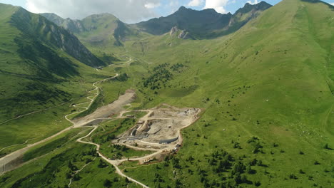 Top-down-aerial-drone-shot-of-a-dam-construction-site-in-the-alpine-mountains