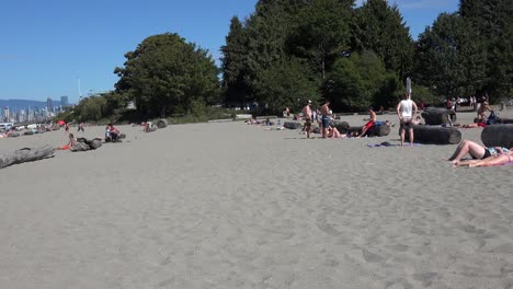 Female-takes-t-shirt-off-showing-bikini-at-beach