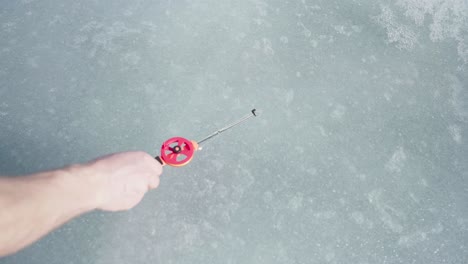 Ice-Fishing-Rod-Lay-Down-On-A-Frozen-Landscape