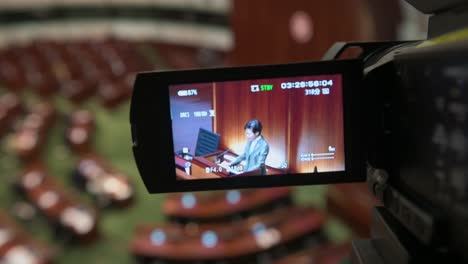 News-coverage-and-camera-film-Carrie-Lam,-former-Hong-Kong-chief-executive,-delivers-annual-policy-address-at-the-Legislative-Council-Chamber-in-Hong-Kong