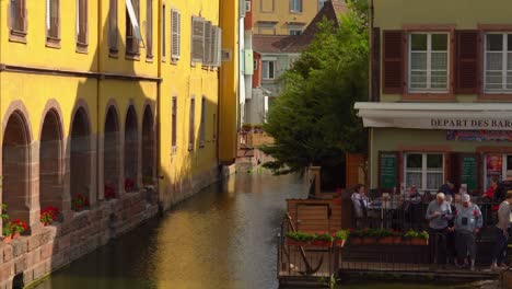 People-Admire-the-typical-Alsatian-half-timbered-houses-along-the-riverbanks-in-La-Petite-Venise-district-of-Colmar-city