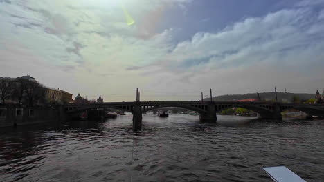 Bridge-above-river-crosses-Czech-Republig-Prague-Landscape-skyline-shining-water-still-at-European-capital