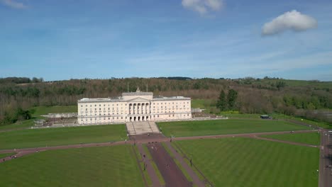 Wide-shot-of-Stormont,-Belfast-Parliament-Buildings-from-above-on-a-sunny-day-with-camera-rising-low-to-high