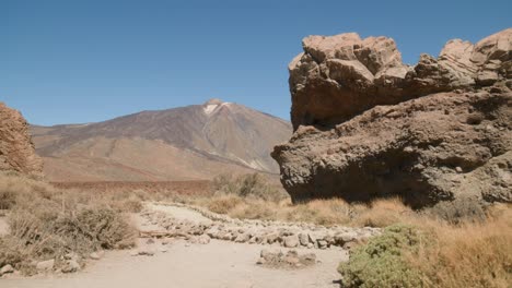 Mount-Pico-del-Teide-revealed-behind-volcanic-rocks,Los-Roques-de-Garcia,-Teide-National-Park-in-Tenerife,-Canary-Islands-in-spring