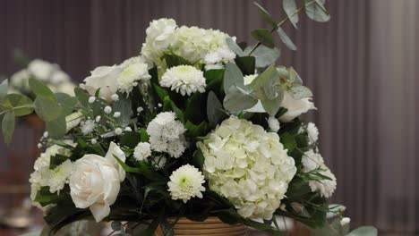 An-arrangement-of-white-flowers-as-a-centerpiece-for-a-wedding-reception