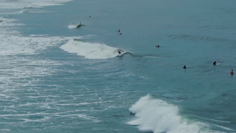 Surfer-Getting-Up-and-Riding-a-Wave-in-Ocean,-South-America,-Brazil,-Summertime