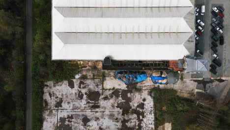 White-rooftop-of-abandoned-building-in-Ghent,-aerial-top-down-view