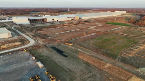 Low-flying-drone-reveal-of-Ford's-Megacampus,-BlueOval-City-at-Sunset-in-Stanton,-TN